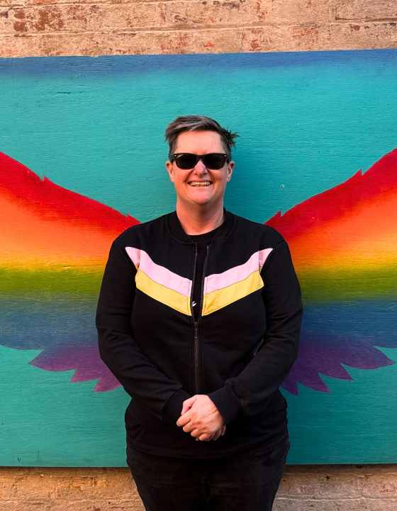 Q Blog Rae Portrait with Rainbow Wall